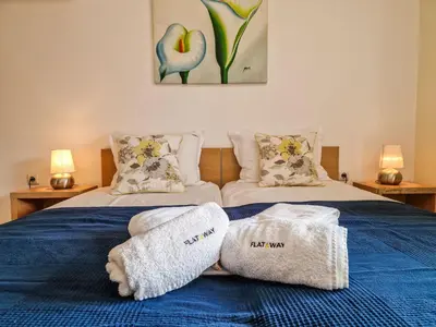 a bedroom with two beds with towels on them at Cedar Lodge 2 Bedroom Apartment by Flat Mаnager in Bansko