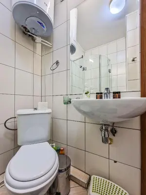 a bathroom with a toilet and a sink at Cedar Lodge 2 Bedroom Apartment by Flat Mаnager in Bansko