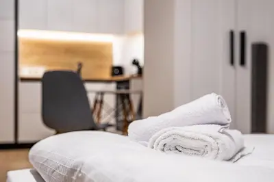 a pile of towels sitting on top of a bed at Stylish Studio with Free Parking in Sofia