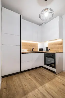 a kitchen with white cabinets and a sink at Stylish Studio with Free Parking in Sofia