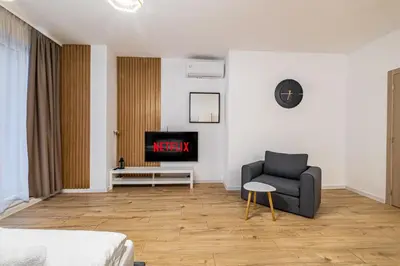 a living room with a couch and a tv at Stylish Studio with Free Parking in Sofia