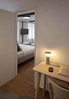 a bedroom with a bed and a table with a lamp at Ruby Red House in Sofia