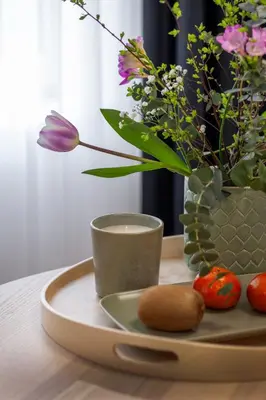 a tray with a vase and flowers on a table at Ruby Red House in Sofia