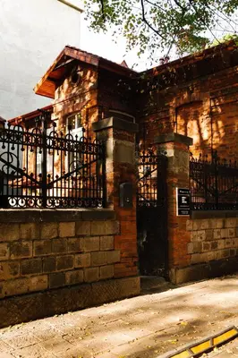 a brick building with a gate and a fence at Ruby Red House in Sofia