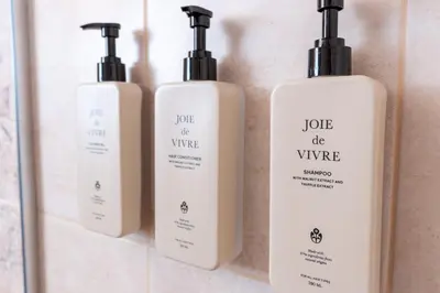 a group of three bottles of soap on a shelf at Apart house EMA 2 in Bansko