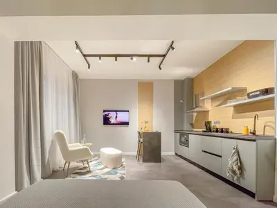 a bedroom with a kitchen and a living room at Stylish City Center Apartment by NDK in Sofia