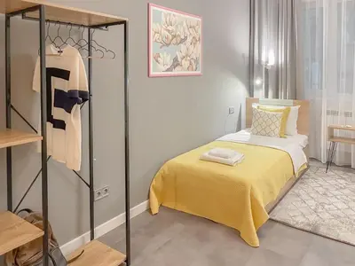 a bedroom with a bed with a yellow blanket at Stylish City Center Apartment by NDK in Sofia