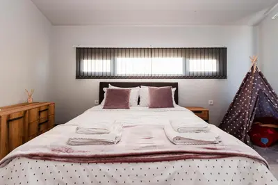 a bedroom with a large bed with blankets and pillows at Alexandra Family Estate in Samoranovo