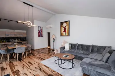 a living room with a couch and a table at Alexandra Family Estate in Samoranovo