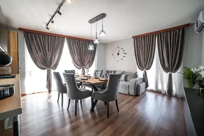 a living room with a dining room table and chairs at Apartment Tiana Lux 2 in Hisarya