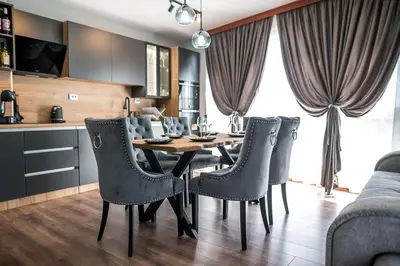 a kitchen and dining room with a table and chairs at Apartment Tiana Lux 2 in Hisarya