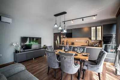 a kitchen and dining room with a table and chairs at Apartment Tiana Lux 2 in Hisarya