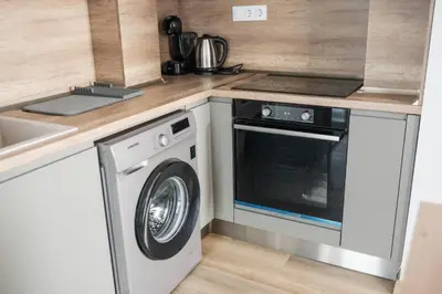 a kitchen with a washing machine and a sink at ТОП Апартаменти в Панорама Парк in Plovdiv