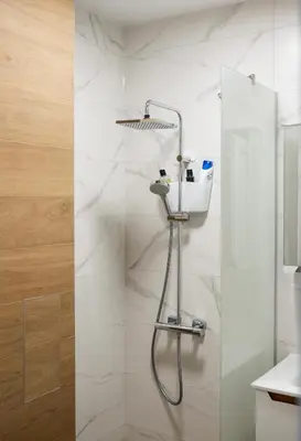 a shower in a bathroom with white tiles at ТОП Апартаменти в Панорама Парк in Plovdiv