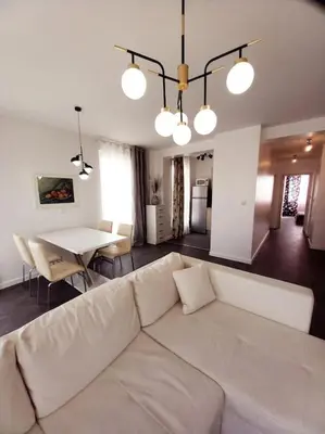 a living room with a white couch and a table at Luxury Apartment two bedrooms Paul Sеzanne in Hisarya
