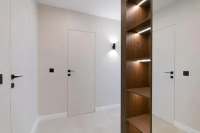 a walk in closet with white cabinets and a door at Cozy Elegant 2BR Apt + Free Parking next to Paradise Mall in Sofia