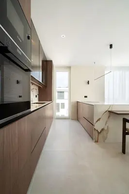 a large white kitchen with a counter and a sink at Cozy Elegant 2BR Apt + Free Parking next to Paradise Mall in Sofia