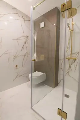 a bathroom with a glass shower with a toilet at Cozy Elegant 2BR Apt + Free Parking next to Paradise Mall in Sofia