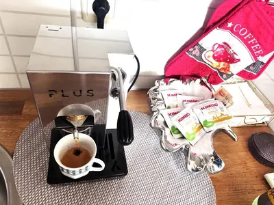 a coffee maker with a cup of coffee on a table at VANITY Apartments in Sandanski