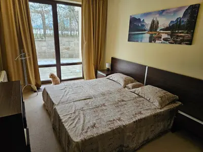 a bedroom with a bed and a large window at TERRA COMPLEX D5 - Private apartment - Golf, Skiing & SPA in Razlog