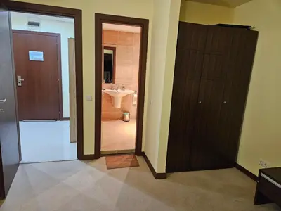 a bathroom with a toilet and a sink and a door at TERRA COMPLEX D5 - Private apartment - Golf, Skiing & SPA in Razlog
