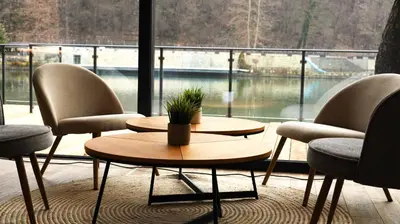 a room with two tables and chairs and a large window at Waterside SPA Hotel in Ognyanovo