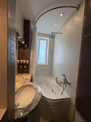 a large bathroom with a tub and a sink at Vitosha Sunrise in Sofia