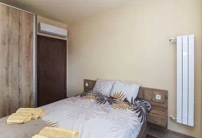 a bedroom with a bed with two towels on it at Cherkovna Residence Apartment plus GARAGE !!! in Sofia