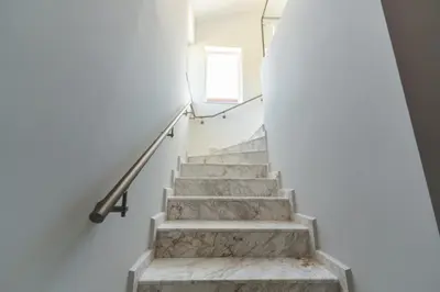 a staircase in a house with a window at ENEVI Guest Houses-Къщи за гости Еневи in Sandanski