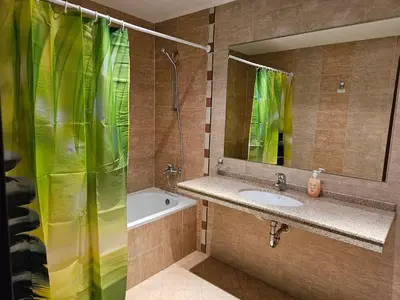 a bathroom with a sink and a shower with a mirror at TERRA COMPLEX B4 - Private apartment - Golf, Skiing & SPA in Bansko