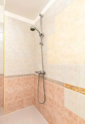 a shower with a hose in a bathroom at La Primavera Spacious Apartment in Plovdiv