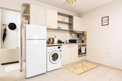 a kitchen with a white refrigerator and a washer at Studio 'Ozi' quite place in Perfect Center in Plovdiv