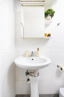 a white bathroom with a sink and a mirror at Studio 'Ozi' quite place in Perfect Center in Plovdiv