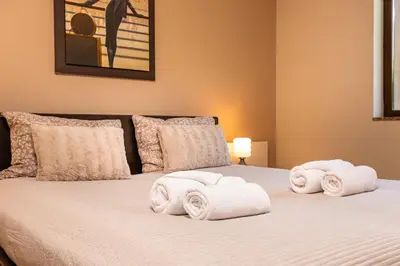 a bedroom with two white towels on a bed at Beautiful apartment in the heart of Plovdiv in Plovdiv