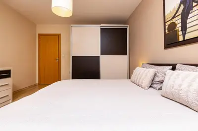 a bedroom with a large white bed in a room at Beautiful apartment in the heart of Plovdiv in Plovdiv