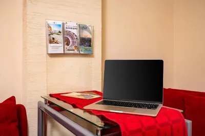a laptop computer sitting on a glass table in a room at Beautiful apartment in the heart of Plovdiv in Plovdiv