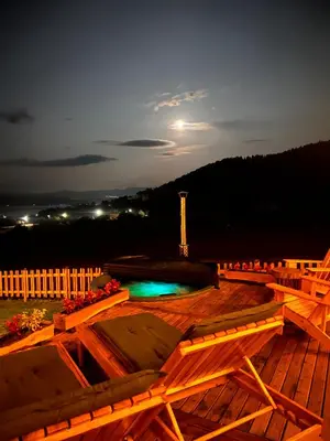 a deck with a pool and a monument in the background at Kare Luxury Chalets in Tsigov Chark