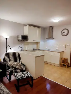 a kitchen with a chair and a table and a clock at GALA 2Bedroom Apartment 200m from Gondola in Bansko