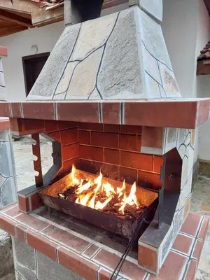 a brick oven with fire inside of it at Villa Victoria in Stoykite