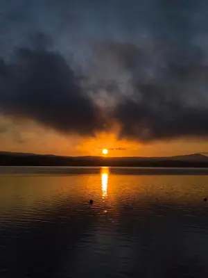a sunset over a large body of water at Villa Iskar Lake Residence by BookVillaBG in Shtarkelovo Gnezdo