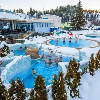a group of people in a swimming pool in the snow at lux apartament К602 in Bansko