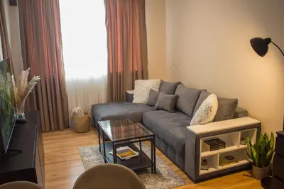a living room with a couch and a table at EVIAS Apartment in Sandanski