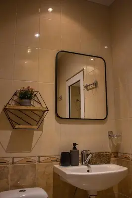 a bathroom with a sink and a mirror at EVIAS Apartment in Sandanski