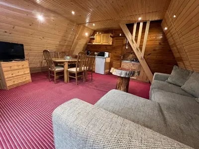 a living room with a couch and a table at Chalet Musala Borovets by BookVillaBG in Borovets