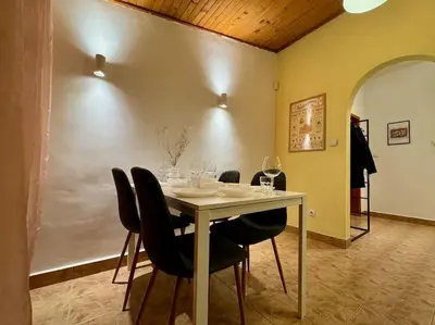 a dining room with a table with wine glasses on it at Sofia Sweet Spot: Central & Cozy in Sofia