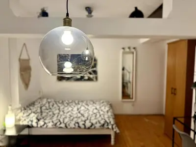 a room with a bed and a pendant light at Sofia Sweet Spot: Central & Cozy in Sofia