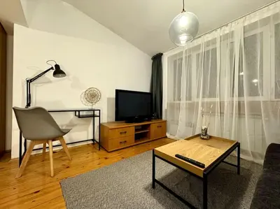 a living room with a television and a chair at Sofia Sweet Spot: Central & Cozy in Sofia