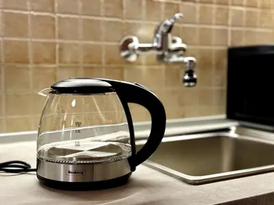 a tea kettle on a kitchen counter next to a sink at Sofia Sweet Spot: Central & Cozy in Sofia