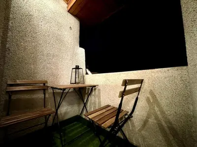 a table and a chair next to a window at Sofia Sweet Spot: Central & Cozy in Sofia