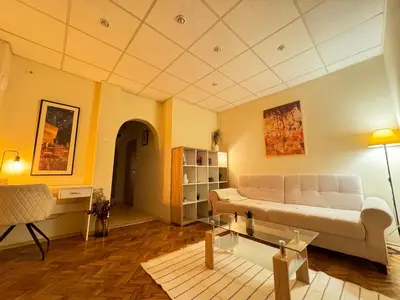 a living room with a couch and a table at Cozy and quiet central apartment in Sofia